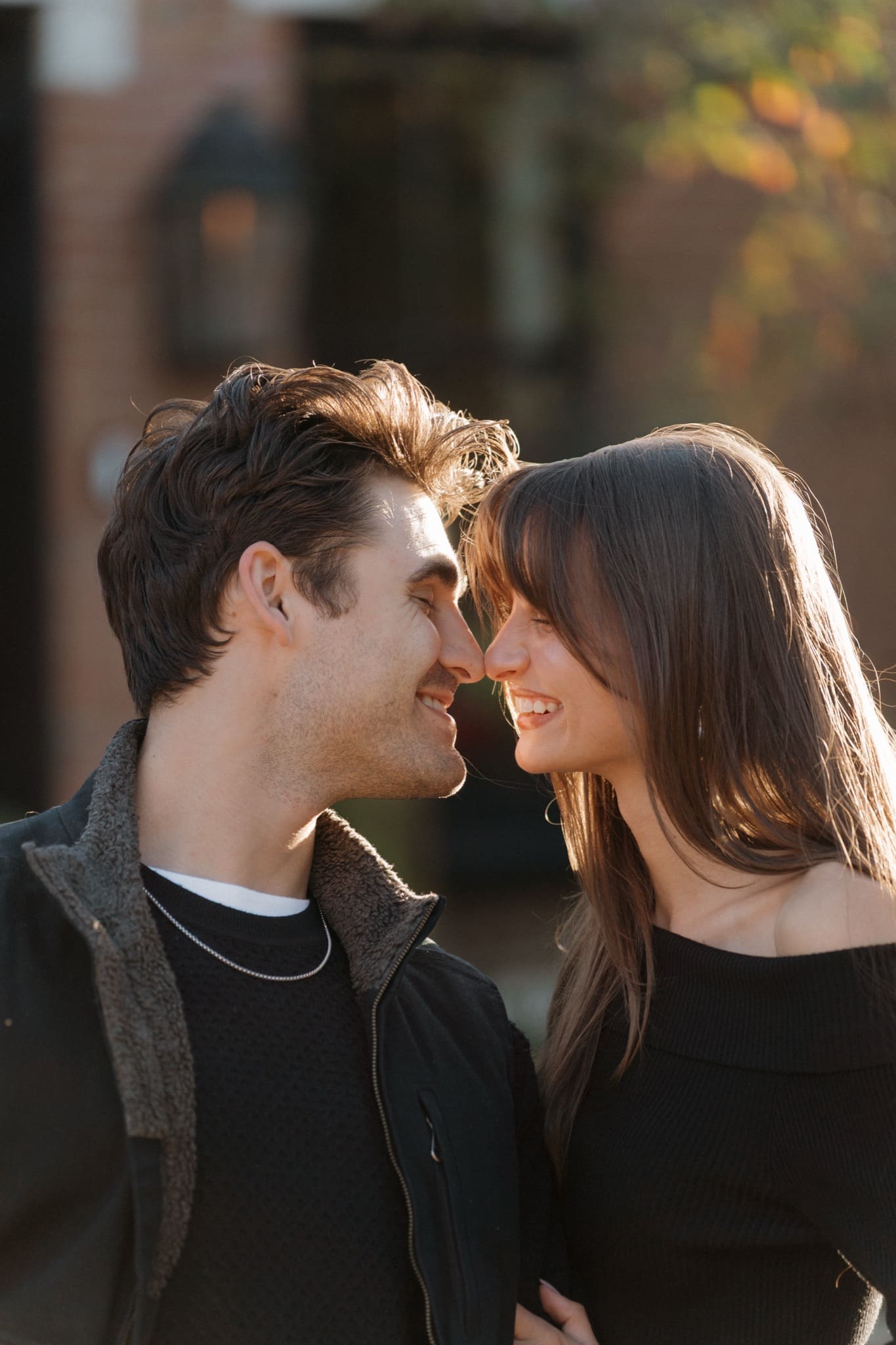 Close-up of a couple touching noses at golden hour during a German Village engagement session in Columbus