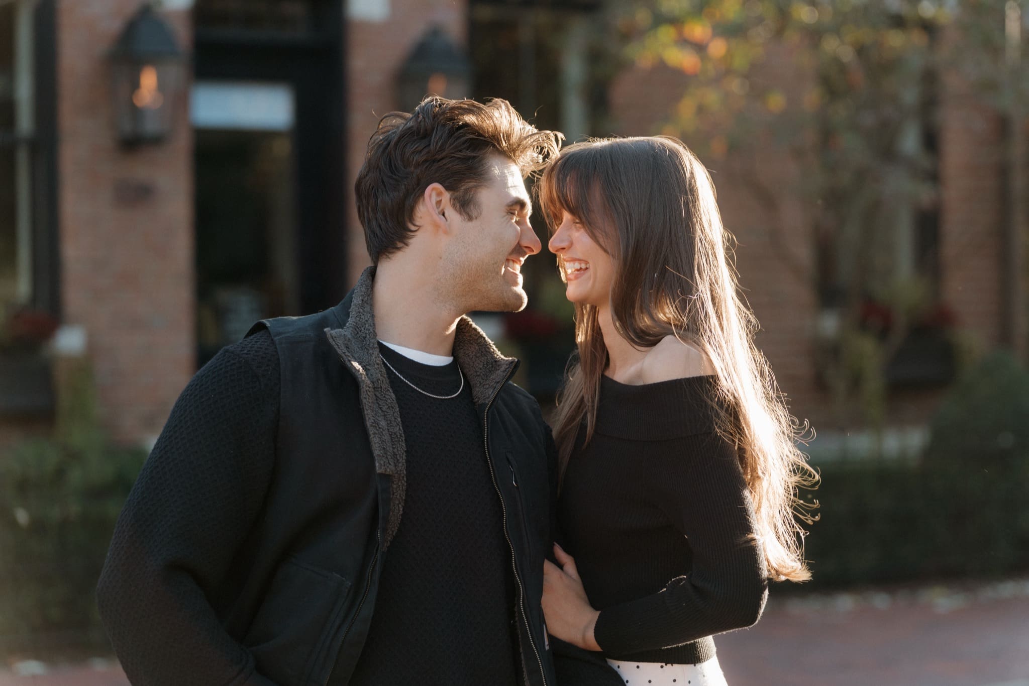 Couple laughing together on a brick street in German Village at sunset, Columbus Ohio engagement photos